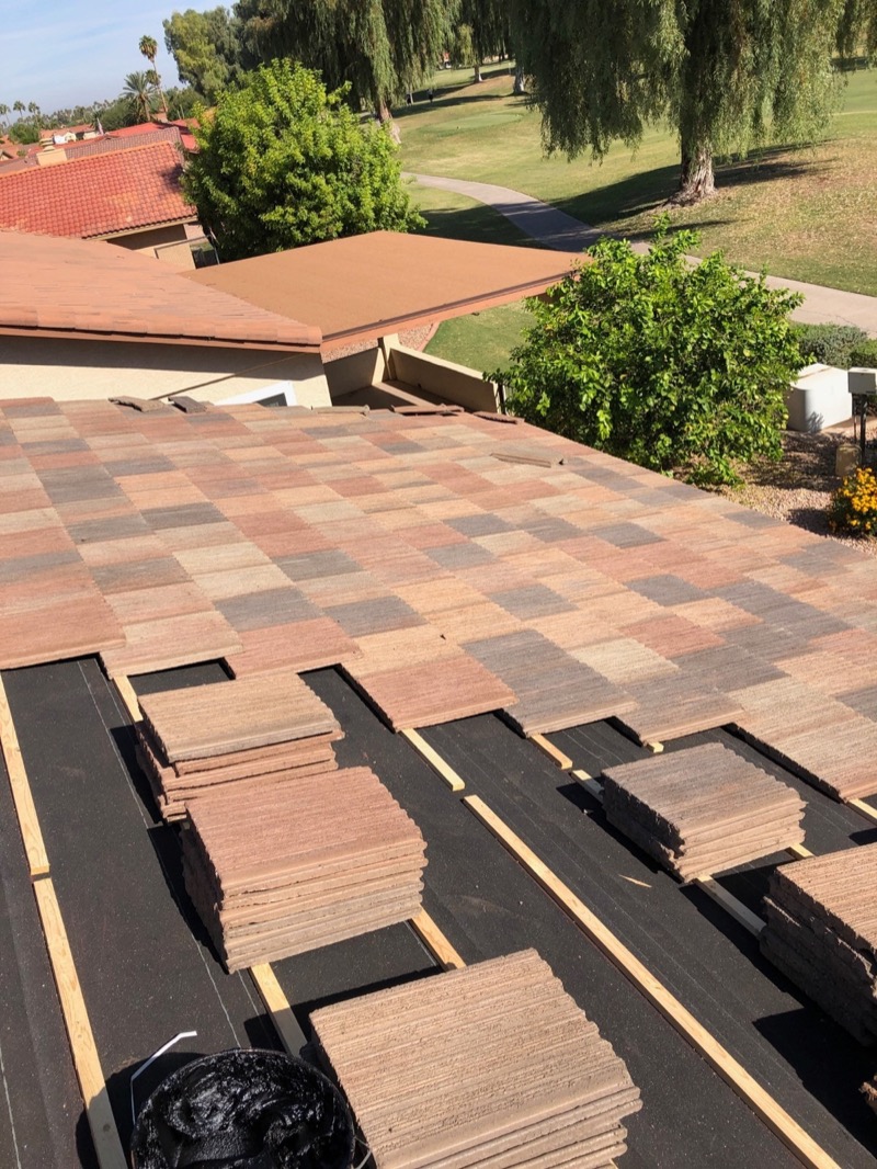 Tile underlayment replacement in progress - tiles stacked on new underlayment at Mesa AZ home